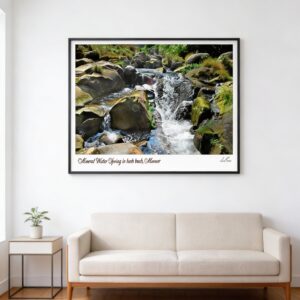 Natural rock waterfall stream framed wall art above beige sofa in modern living room with wooden floor